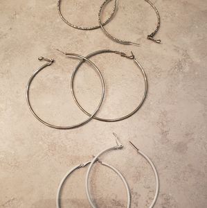3 pairs of hoop earrings. White, silver and sparkly silver hoops. Like new.